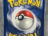 a pokemon card in a plastic case on a table