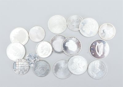 several different types of coins are arranged on a white surface