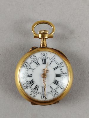 a gold pocket watch with roman numerals on it