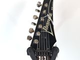 the neck of an electric guitar with a guitar pick up on it