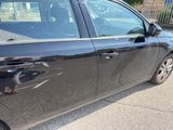 a black car parked on the side of the road