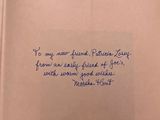 an open book with a handwritten quote on it