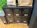 a brown bag sitting on top of a metal locker
