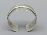 sterling cuff bracelet with a wide band and a curved design