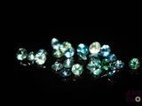a group of blue and green diamonds on a black surface