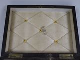a black suitcase with gold buttons on the inside