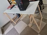 a laptop sitting on top of a table on top of a desk