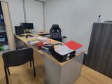a desk with a chair and a computer on it in a room