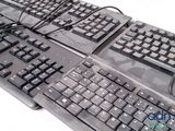 two keyboards and a mouse sitting on a table