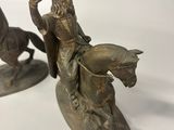 pair of bronze figurines of a man on a horse and a man on a horse