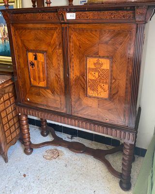 a wooden cabinet that has a door on top of it
