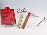 a red case with a knife, a book, and a pair of scissors
