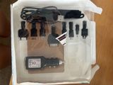 a box containing a charger, a car charger, and a charger