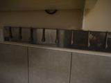 a picture of a kitchen with a lot of utensils hanging on the wall