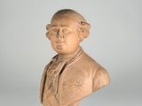 an antique bust of a man wearing a suit and tie