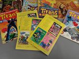 a lot of comic books on the table