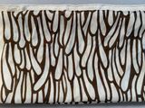 a close up of a brown and white bag on a table