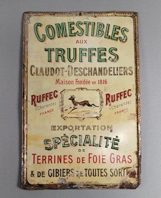 une affiche accrochée au mur sur laquelle on peut lire « comestiles et truffes »