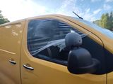 a yellow van that has a black helmet on it