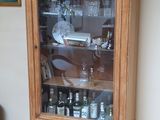 une armoire en bois avec une porte vitrée dans un salon