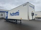 the trailer is parked in front of a building with a blue and white logo on it