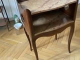 a wooden table with a marble top in a living room