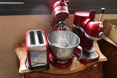 a red mixer and a blender sitting on a counter