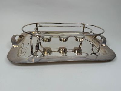 silver plated serving tray with four cups and saucers on it