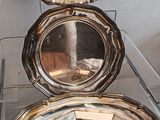 three silver trays stacked on top of each other on a table