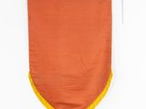 an orange and yellow flag hanging on a white wall