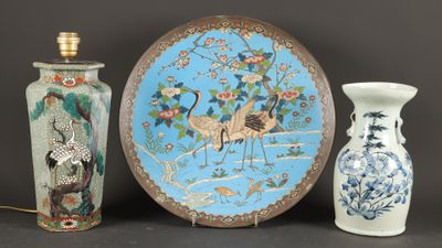 three vases and a plate sitting on a table