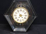 a clock that is sitting on a table with a black background