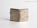 an image of a silver box sitting on top of a white surface