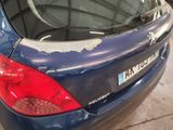 a blue car that has a broken window in the back of it