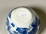 a blue and white bowl with a label on it