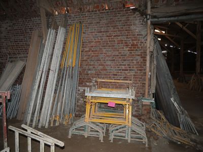 a pile of old metal and wood pieces in a room