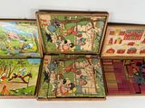 three wooden puzzles in a box with pictures of people and animals