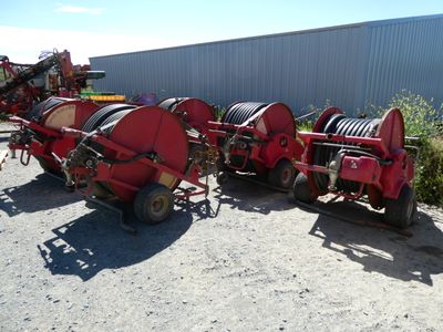 a picture of a row of farm equipment parked in a lot