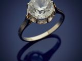 an old cut diamond ring on a blue background
