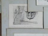 several drawings of a cat and a bird are on a table