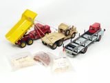three toy trucks that are sitting next to each other