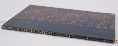 an old book sitting on top of a white table