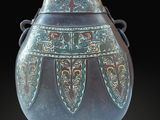 a vase that is sitting on a black surface