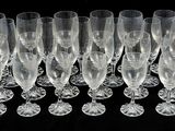 a lot of wine glasses that are lined up together