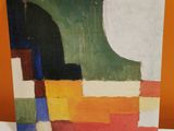 abstract painting on a white table with orange wall in the background