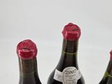 three bottles of wine sitting next to each other on a table