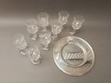a lot of glasses and a silver plate on the table