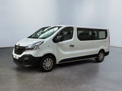 the small white van is parked in a large room