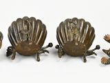 three bronze figurines of a turtle, a shell and a turtle