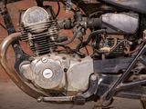 a close up of an old motorcycle with a small engine